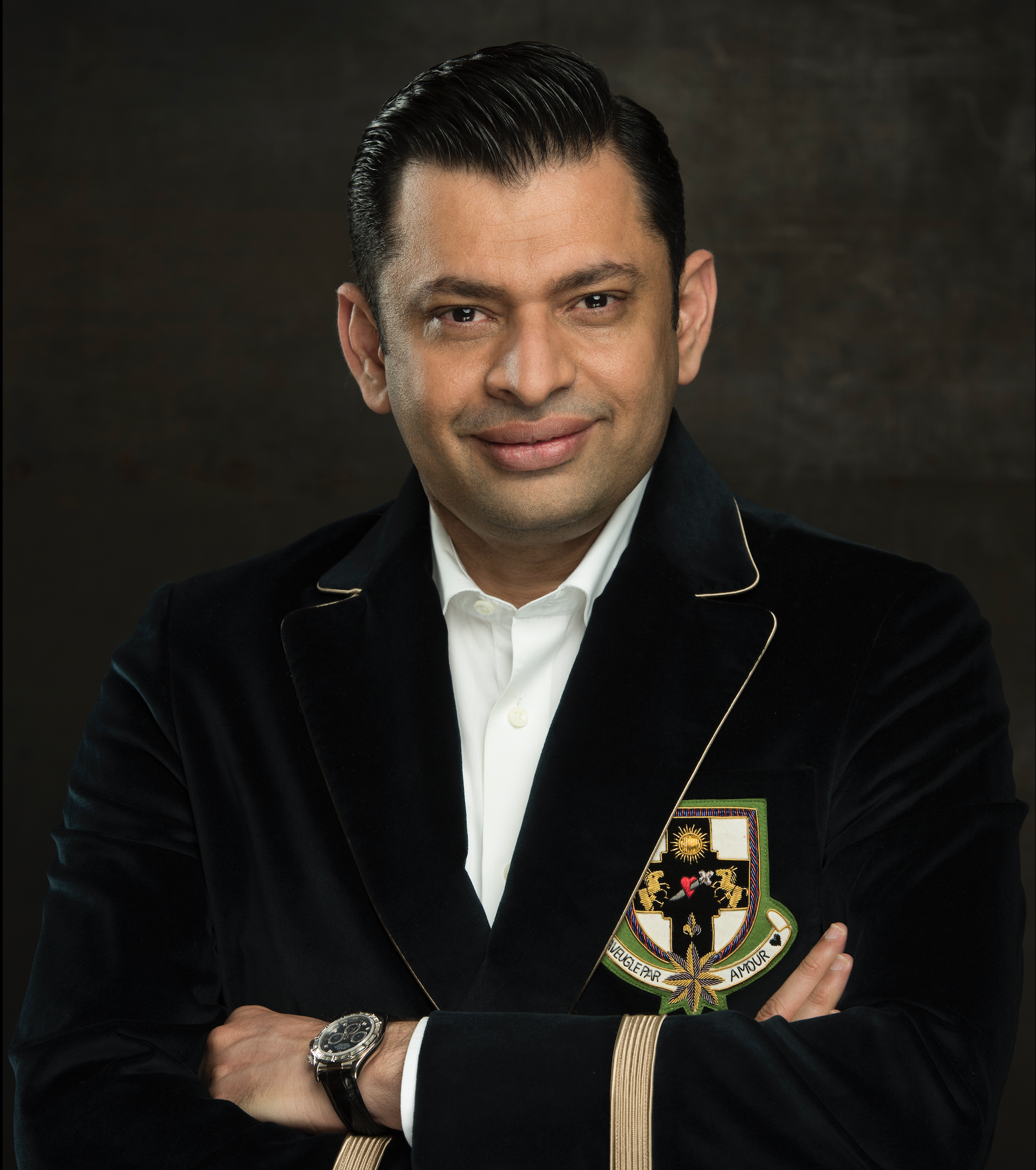 Professional headshot of a Veris Investment executive in a black suit , Ali Rao ceo of veris